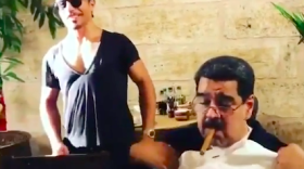 Venezuelan President Nicolas Maduro (right) receiving a T-shirt from celebrity Turkish chef Salt Bae.
