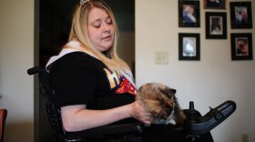 Michelle Fridley, 33, with her cat in her apartment in Canadaigua, N.Y. Ten years ago, on the way to  her baby shower, Fridley, then 23, was in a car accident that left her a  quadriplegic. This year, she was crowned Miss Wheelchair New York.