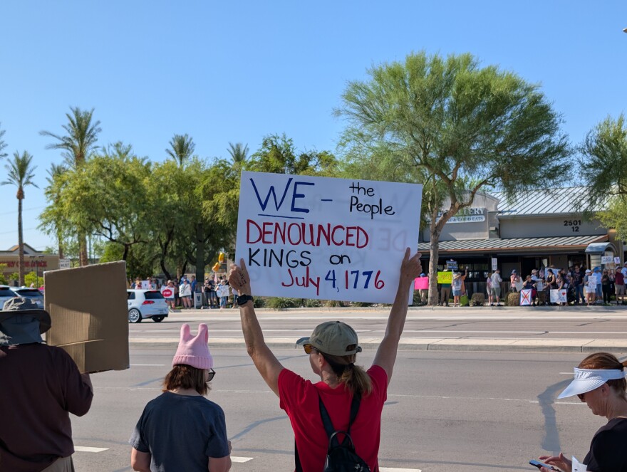 "No Kings" protesters flank Happy Valley Road in north Phoenix on June 14, 2025.