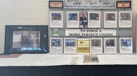 An exhibit table with photos and information