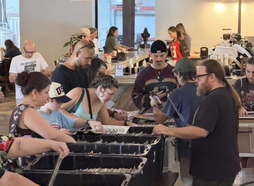 Attendees browse dozens of bins of records at the Gainesville Record Fair in Cypress & Grove Brewing Co. on Sunday.