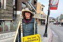 A woman wearing a film reel on her head holds a sign that reads "the last sundance" while attending final Sundance Film Festival in Park City, Utah, on Friday, Jan. 23, 2026, before the festival moves next year to Boulder, Colo.