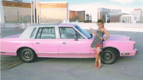 The author in front of her pink Cadillac at the Mirage