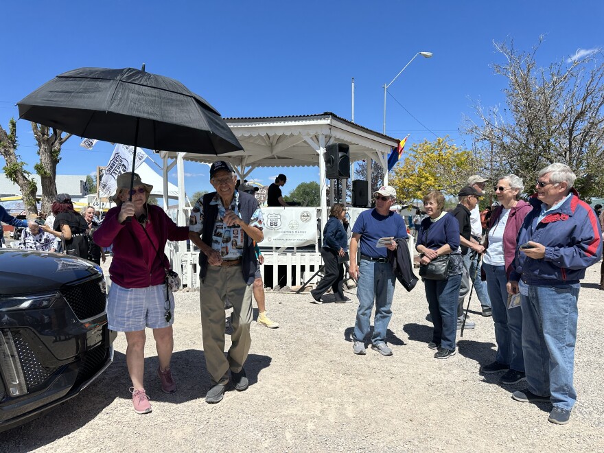 people starting in front of a white gazebo