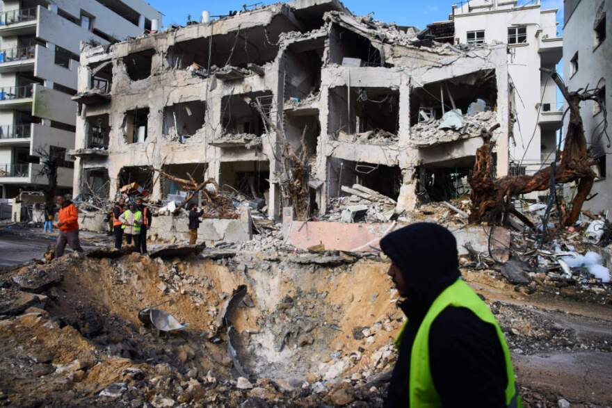 Rescue workers and military personnel survey the scene of a direct hit a day after an Iranian missile struck in Tel Aviv, Israel, Sunday, March 1, 2026. (Oded Balilty/AP)