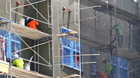 Construction workers plaster the exterior of a new apartment building, July 5, 2023, in Orlando, Fla. Undocumented workers live in fear and anxiety after a new law signed by Florida Gov. Ron DeSantis. The law targets them and employers with 25 or more employees which mandates they verify that their workers are legally allowed to work. Many workers affected are employed in the construction, agriculture and hospitality industries.