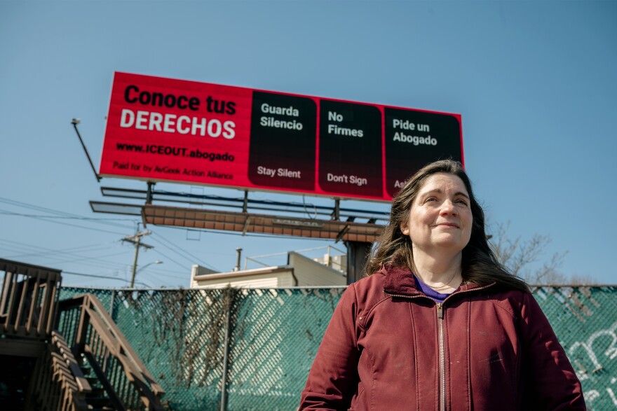 Laura Cassenti, a member of MA/CT Stop Avelo, which protested against Avelo Airlines' participation in deportation flights, stands in front of a billboard advising people of their legal rights during immigration raids, in New Haven on March 11, 2026. The sign originally meant to advertise a boycott against Avelo, is now running until March 22nd.
