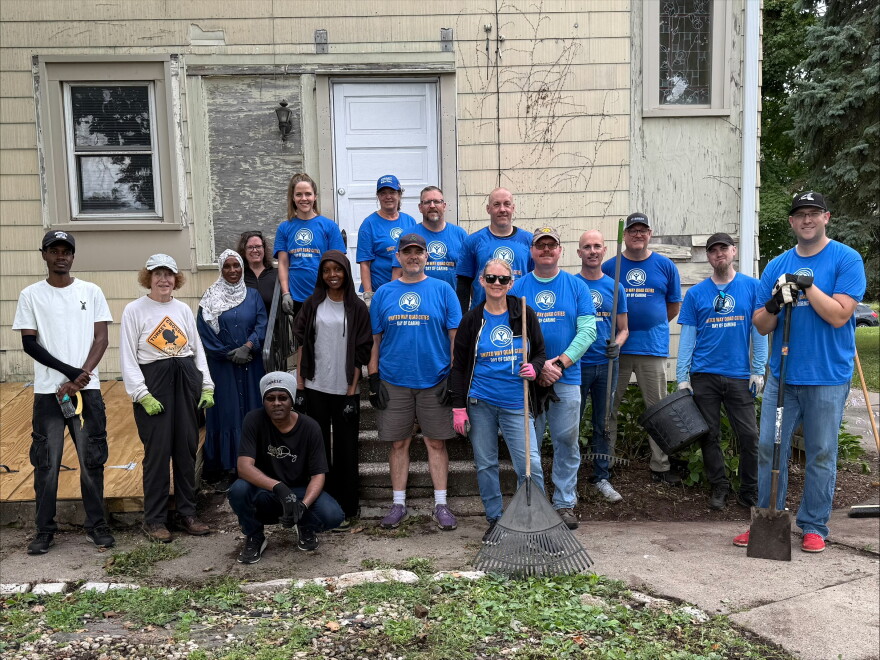 Volunteers as part of United Way Day of Caring, responsible for sprucing up the two yards.