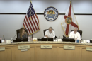City council members sit in chairs