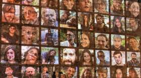 People walk outside the walls of the old city of Jerusalem, on which are projected pictures of the hostages abducted by Palestinian militants on the October 7 attack and currently held in the Gaza Strip, on November 6, 2023, amid the ongoing battles between Israel and the militant group Hamas. (Photo by AHMAD GHARABLI / AFP) (Photo by AHMAD GHARABLI/AFP via Getty Images)