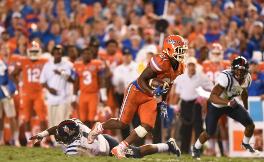 Florida running back Kelvin Taylor (21) breaks free of Ole Miss linebacker Denzel Nkemdiche (4) and heads up field.