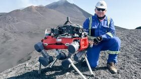 Dr. Andres Diaz on Mount Etna with the ARAMMIS legged robot that is carrying the INFICON Transpector® MPH (quadrupole mass spectrometer)
