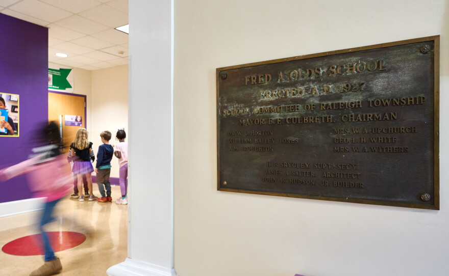 A sign for the Fred A Olds Elementary School hangs at the front entrance while students walk by on Wednesday October 7, 2026.