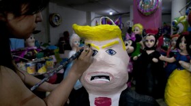 Alicia Lopez Fernandez paints a pinata depicting Donald Trump at her family's store "Pinatas Mena Banbolinos" in Mexico City. In a surprise move, Donald Trump will travel to Mexico on Wednesday, Aug. 31, to meet with President Enrique Pena Nieto, just hours before the Republican delivers a highly anticipated speech on immigration. (Marco Ugarte/AP)