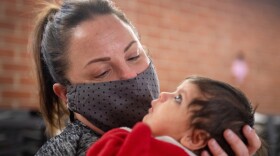 Dr. Courtney Barnes, an OBGYN at the University of Missouri hospital, holds a baby during a prenatal and baby care clinic before the start of the Catholic Charities Refugee Services Sunday, January 30 at Our Lady of Lourdes Catholic Church in Columbia.