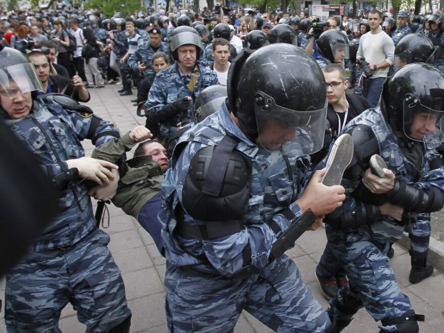 Riot police detain an opposition supporter during an anti-Putin protest in Moscow on Monday. Tens of thousands of people — mostly young Russians — turned out in protest against Putin on Sunday and Monday.