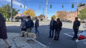 People cross Washington Avenue in Albany on Thursday, Oct. 15, 2026, during an event to recognize White Cane Awareness Day.