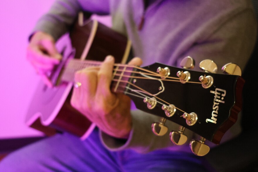 An acoustic Gibson guitar.