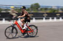 A visitor guides an electric bicycle around a test track at the Electrify Expo, Sunday, July 14, 2024, in north Denver. (David Zalubowski/AP)