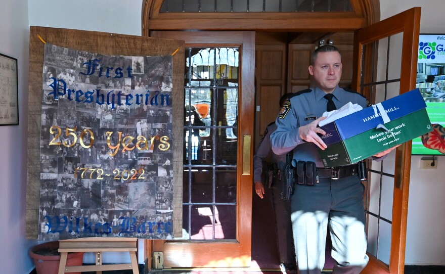 Pennsylvania State Police Trooper Carl Puskar carries valentines out of the Gather Community Space in Wilkes-Barre. He delivered the gifts on behalf of the True Love Movement.