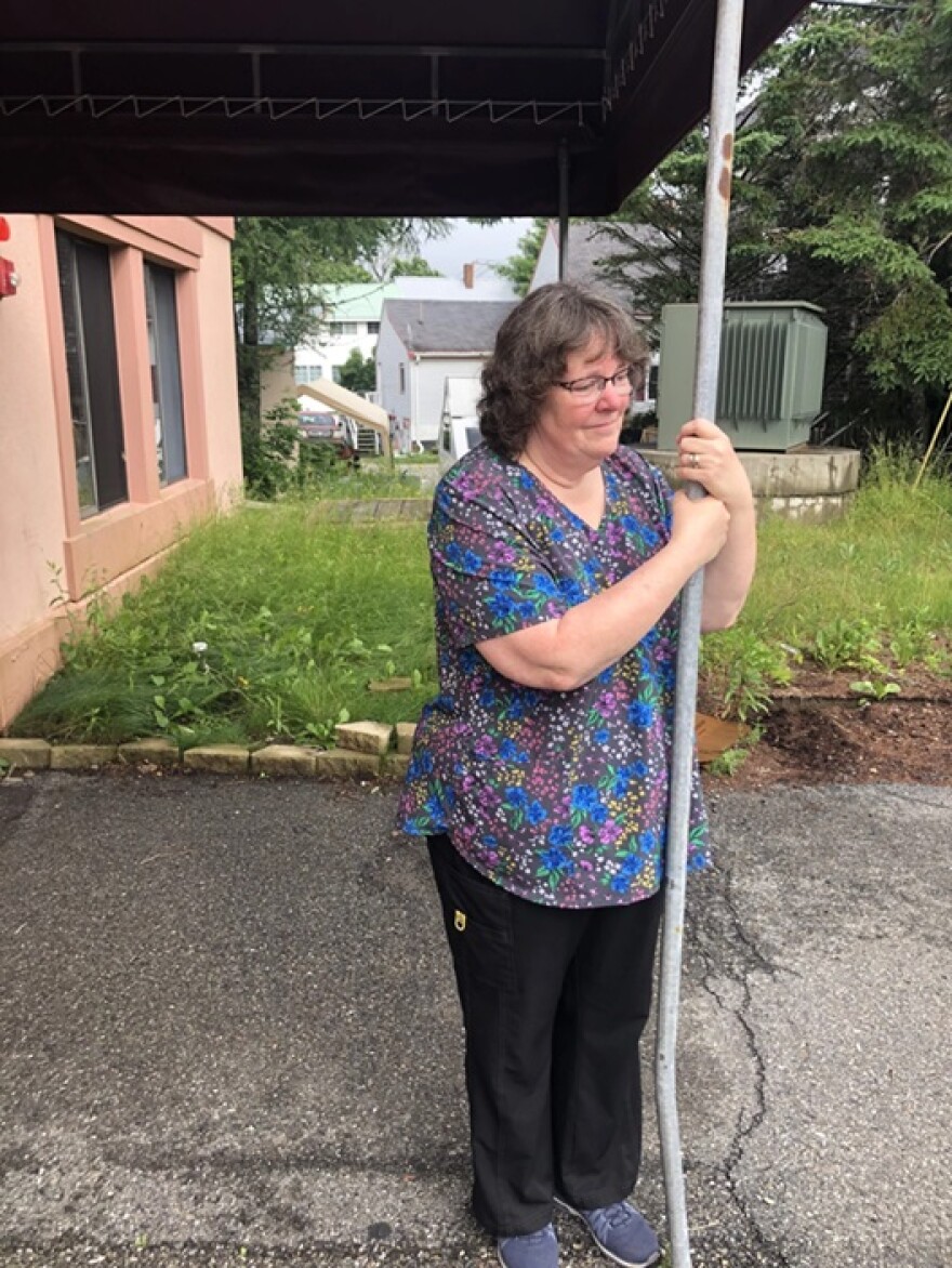 Nurse Theresa Chipman watches as the last resident of Narraguagus Bay Health Care facility is loaded onto an ambulance.