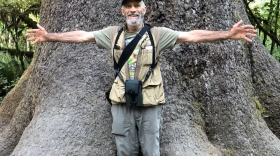 Dale Chorman posing in front of a tree.