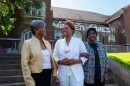VaNetta Clark, a PhD candidate at Washington University in St. Louis, poses for a photo with her former Scullin School teachers Conchita Curry and Magnolia Bush-Tabb.
