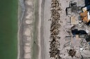 FILE - Waves lap on the beach in front of empty house foundations surrounded by debris, following the passage of Hurricane Milton, on Manasota Key, in Englewood, Fla., Oct. 13, 2024. (AP Photo/Rebecca Blackwell, File)
