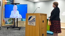 Allen County Public Library executive director Susan Baier stands by as a video from Dolly Parton explaining the mission of the Imagination Library plays.