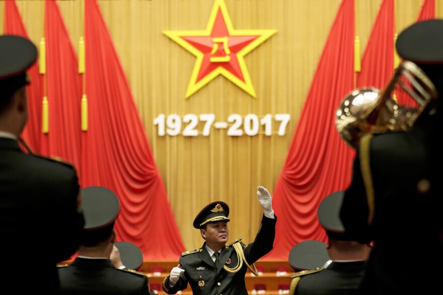 A military band conductor rehearses ahead of the ceremony at Beijing's Great Hall of the People on Tuesday. Chinese President Xi Jinping and many high-ranking officials celebrated the 90th anniversary of the People's Liberation Army with pomp and circumstance.