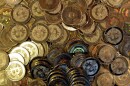 A pile of golden coins with the Bitcoin symbol on them. The Coins also have the text "Bitcoin" at the bottom of their face.