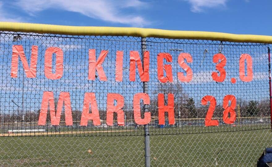 "No Kings 3.0 March 28" Written on chainlink in tape.