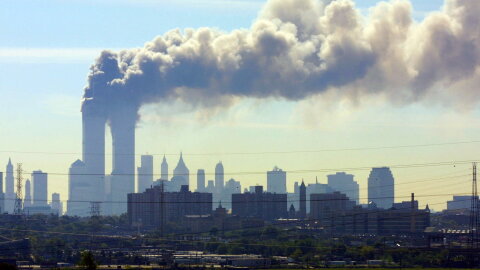 FILE - In this Sept. 11, 2001 file photo, as seen from the New Jersey Turnpike near Kearny, N.J., smoke billows from the twin towers of the World Trade Center in New York after airplanes crashed into both towers. Families of the victims of the worst terror attack on the United States in history gathered Wednesday, Sept. 11, 2013, to mark their 12th anniversary with a moment of silence and the reading of names. The Sept. 11, 2001 attacks in New York City and Washington killed almost 3,000 people and lead to a war in Afghanistan. (AP Photo/Gene Boyars)