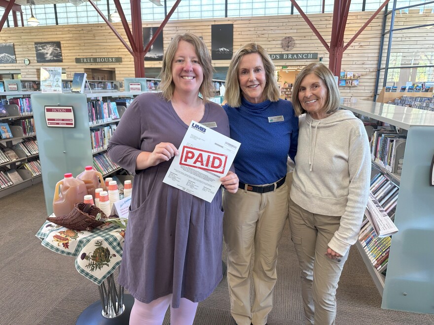 From left to right, Basalt Regional Library Executive Director Amy Shipley, Board of Trustees Treasurer Deborah Smith and President Carolyn Kane celebrate the final debt service payment toward the library’s building construction on Sept. 25, 2025.