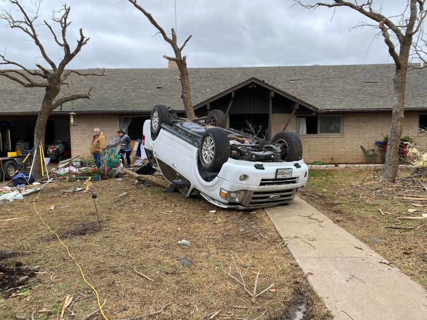  An overturned vehicle in the front yard of a residence in Jacksboro, Texas. The area was hit buy one of several tornadoes that struck Texas Monday March 21, 2022. 