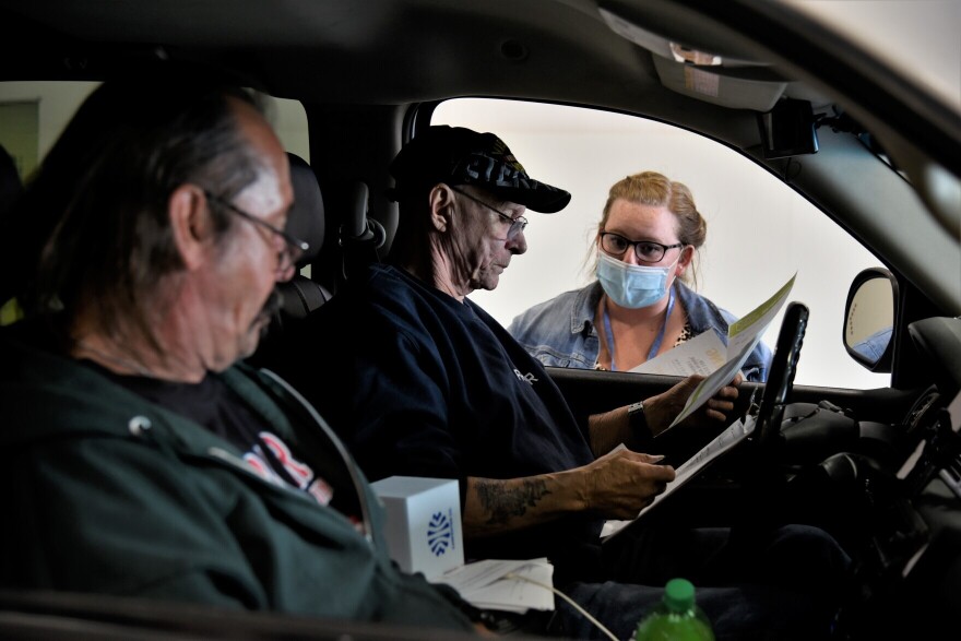 Workers bring their resumes to a drive-thru job fair in Elkhart during the pandemic.