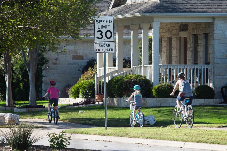 Neighbors ride bicycles in a Cedar Park neighborhood during the coronavirus pandemic.