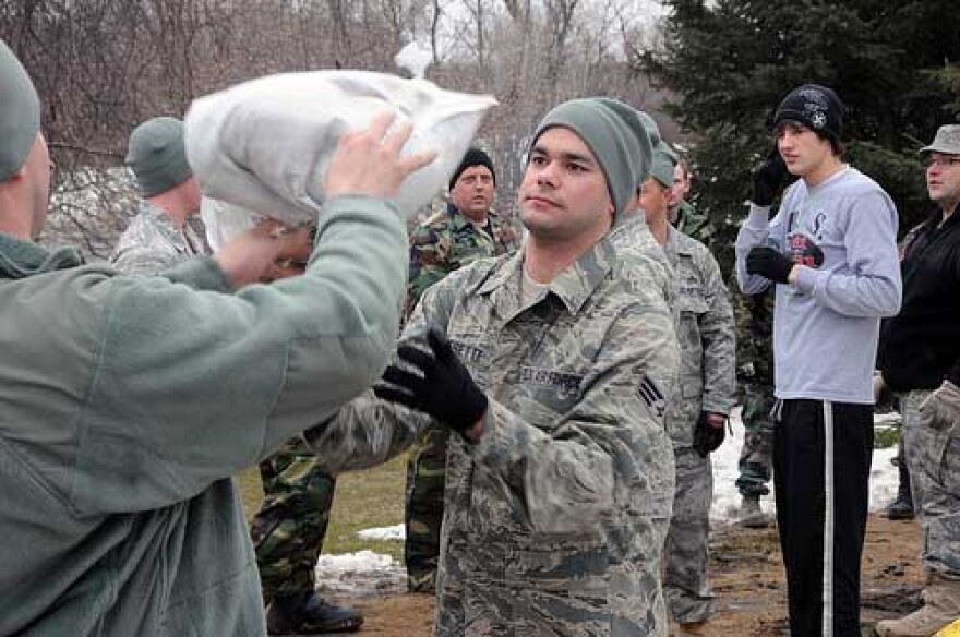 North Dakota National Guardsmen work together with volunteers in sandbag lines to to hold back the rising Red River March 16, 2010 in Fargo, N.D. Illinois scored a 6 out of 10 criteria in a report on preparedness for disasters, such as floods.