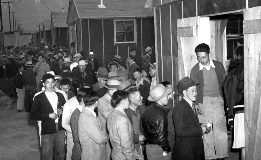 People wait in line for their housing assignment at the Manzanar internment camp in the California desert in 1942. More than 110,000 people of Japanese ancestry were removed from their homes and placed in camps in several states during World War II.