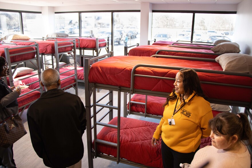 Cara Bushrod (yellow shirt) explains the Emergency Shelter Suite on the first floor of the Snyder Center Thursday afternoon.