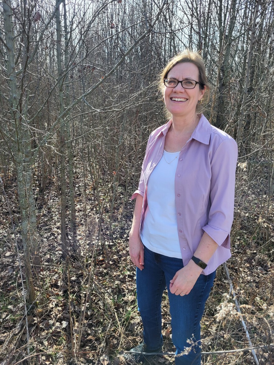 Theresa Culley is the Chair of the Ohio Invasives Plant Assesment Team - stands in front of thicket of wild pear trees.