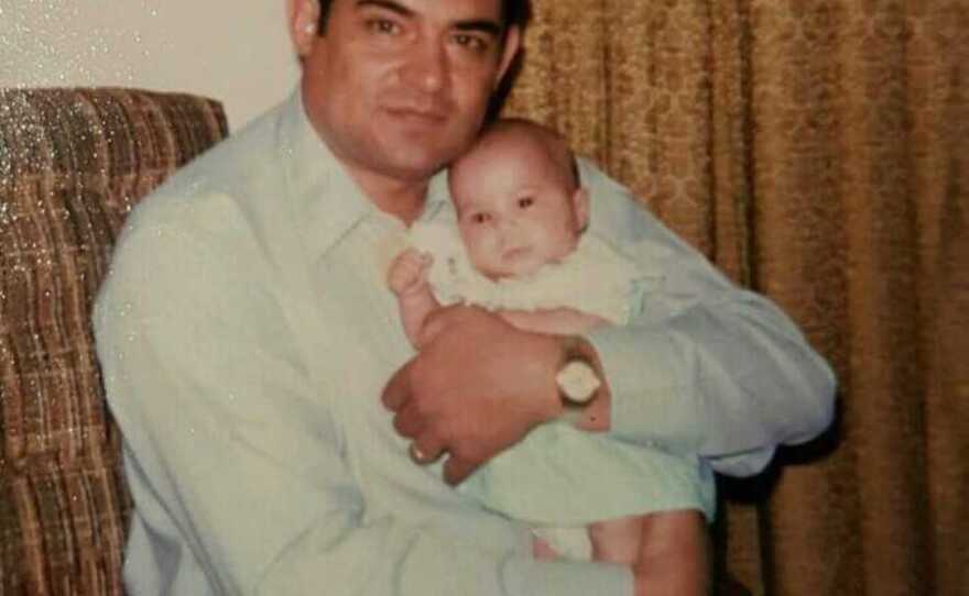 Joe Garcia holds his infant daughter Joanna