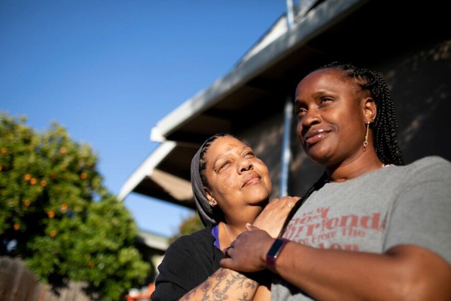 Esther Goolsby, left, and her fiancee, Merika Reagan, at their East Oakland home. Reagan has been renting the house since 2016 and through the Oakland Community Land Trust can now work toward purchasing the property outright.