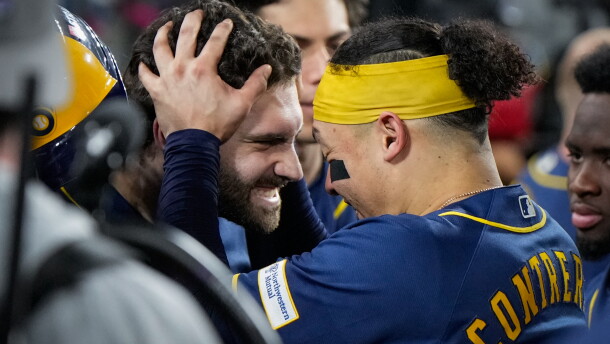 Milwaukee Brewers center fielder Garrett Mitchell celebrates his solo home run with catcher William Contreras in the dugout during the sixth inning of Game 4 of baseball's National League Championship Series between the Milwaukee Brewers and the Los Angeles Dodgers, Thursday, Oct. 15, 2026, in Los Angeles. (AP Photo/Ashley Landis)