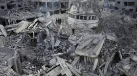 Palestinians inspect the rubble of the Yassin Mosque destroyed after it was hit by an Israeli airstrike at Shati refugee camp in Gaza City, early Monday, Oct. 9, 2023. Israel's military battled to drive Hamas fighters out of southern towns and seal its borders Monday as it pounded the Gaza Strip. (Adel Hana/AP)