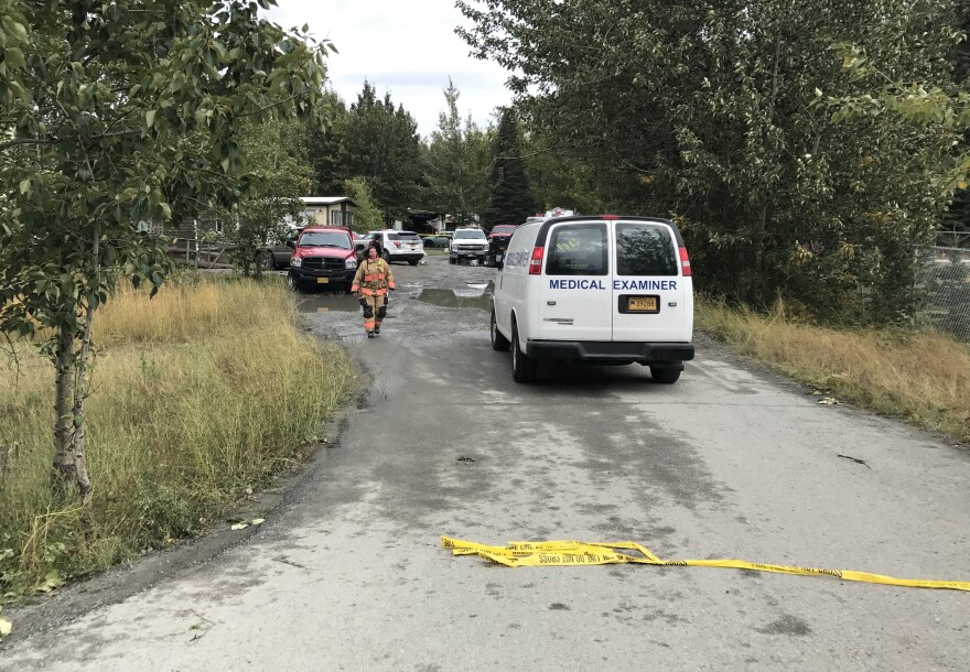 A state medical examiner arrives at the scene of a fatal fire in Butte on Thursday. (Casey Grove/Alaska Public Media photo)