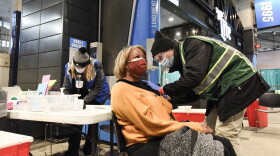 A patient is vaccinated at a mass COVID-19 vaccine clinic at Bank of America Stadium.