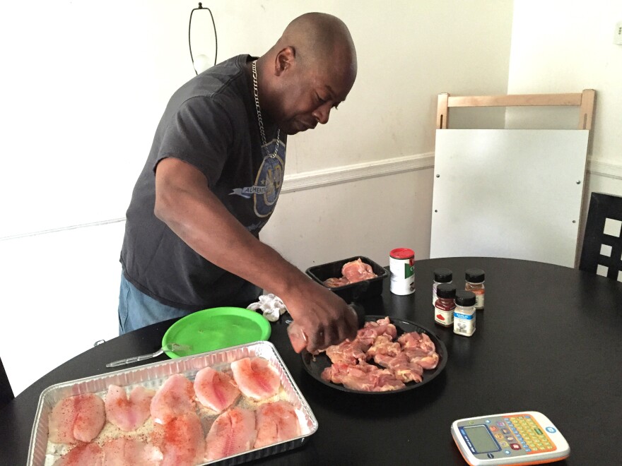 Felipa prepares dinner for his family at their home in West Baltimore, Md.