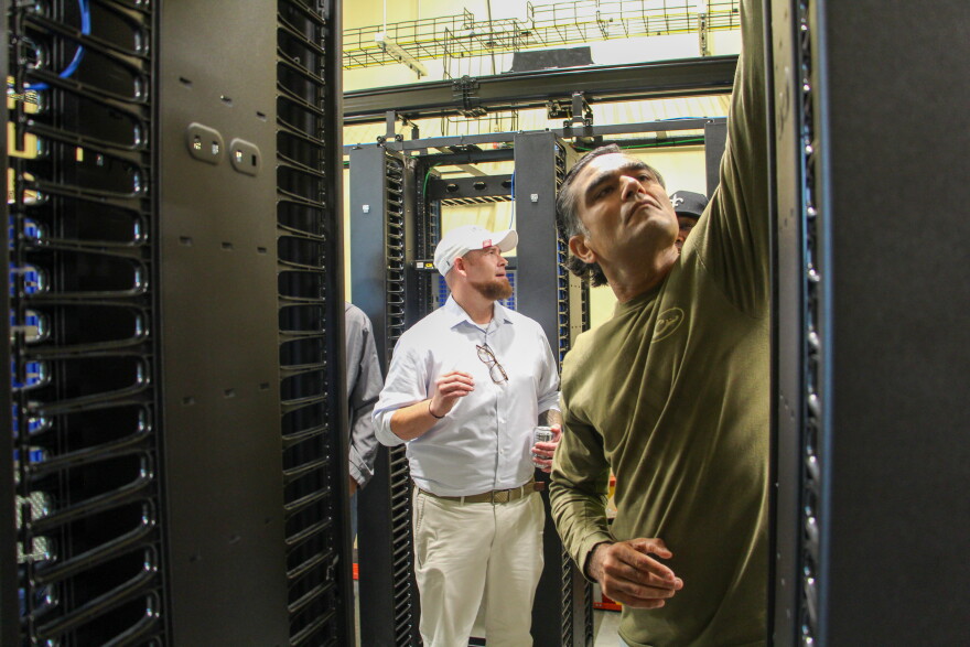 Fletch Batchelor (center) shows students around Louisiana Delta Community College's mock data center on Aug. 18, 2026.