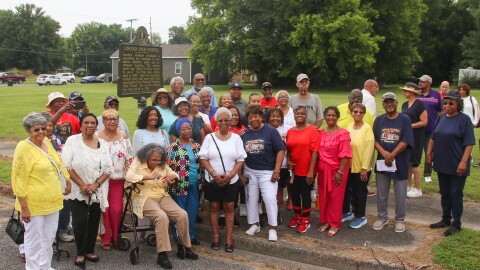 Alumni and former students from Paducah's Lincoln High School gather for a photo in front of a Kentucky Historical Society marker that was unveiled Friday recognizing the school that educated the city's Black students for nearly 70 years before its closure in 1965.